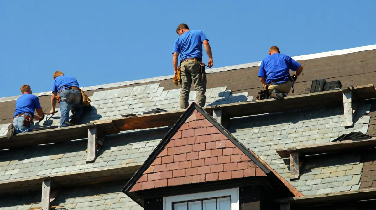 Roof replacement in progress with a team of professional contractors installing new shingles on a residential home in Arlington, TX