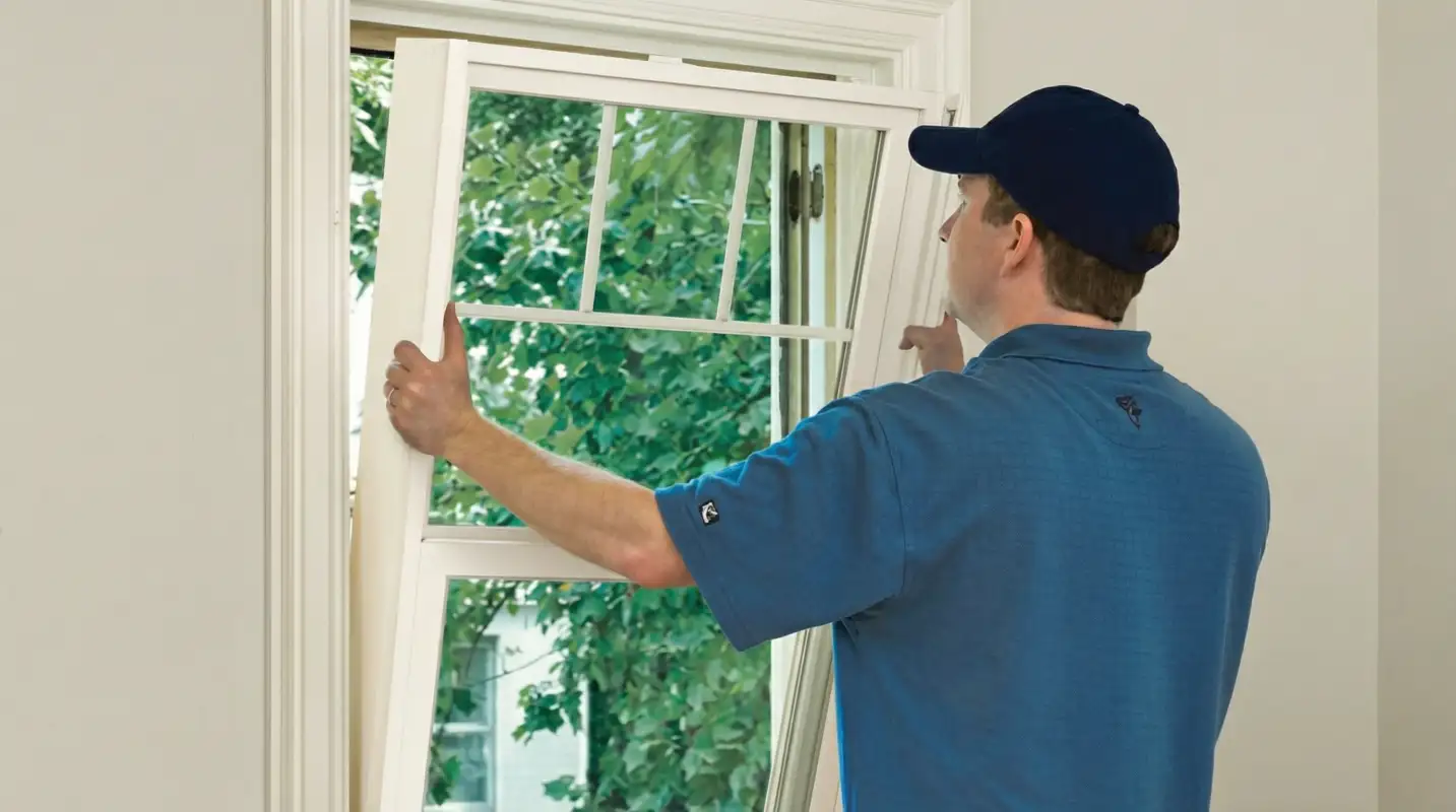 Professional contractors performing a residential window insulation and replacement service in Arlington, TX